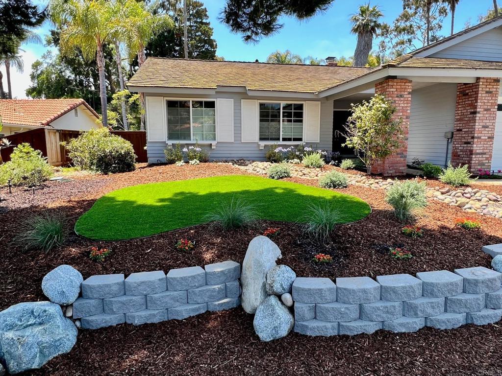 a view of a patio with plants and chairs