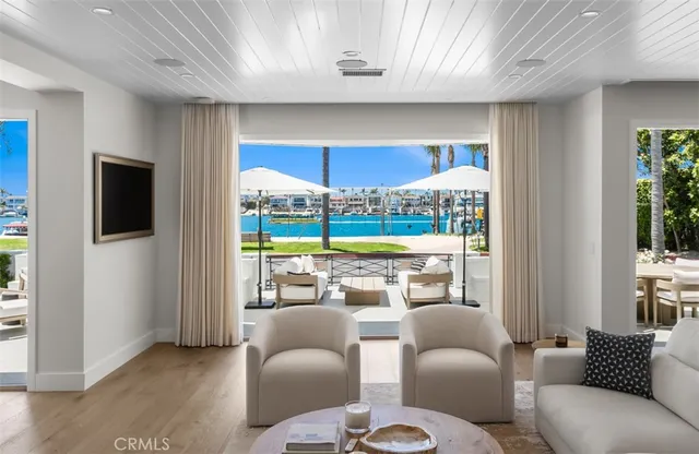 a living room with kitchen island furniture and a chandelier
