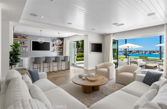 a open kitchen with a table chairs and a flat screen tv