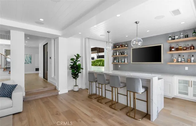 a large kitchen with stainless steel appliances a large counter top oven and cabinets