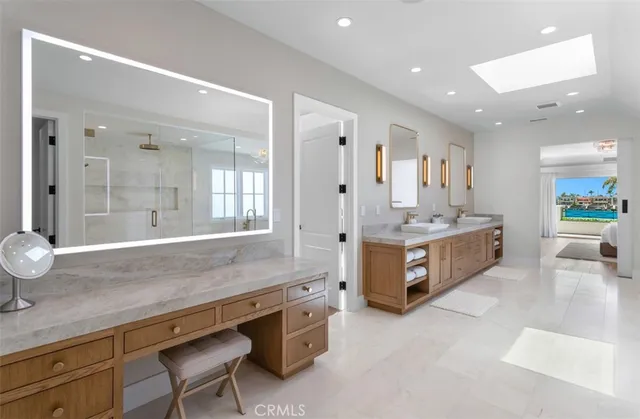 a bathroom with a tub shower sink and mirror