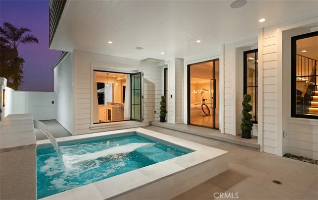 a view of swimming pool with chairs and umbrella