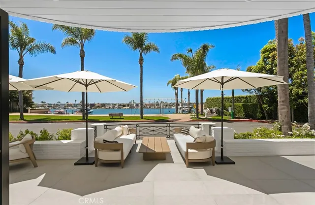 a view of a swimming pool with a table and chairs under an umbrella