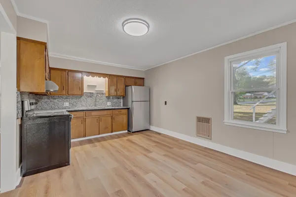 a kitchen with stainless steel appliances granite countertop a stove and a sink