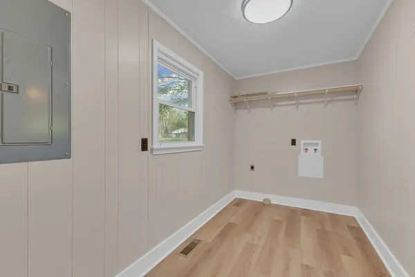 a view of a room with wooden floor and windows