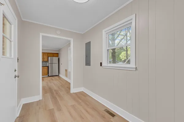 wooden floor in an empty room with a window