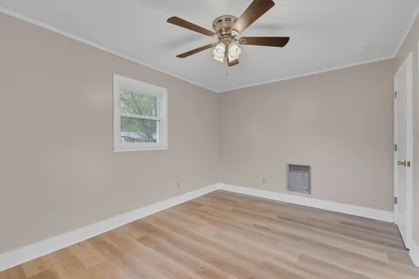 wooden floor in an empty room with a window
