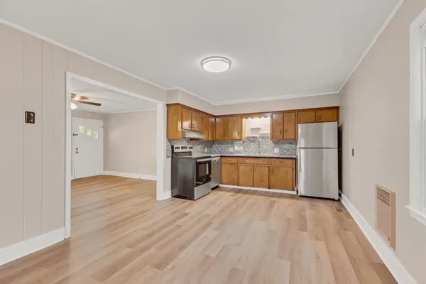 a view of kitchen with cabinets and wooden floor