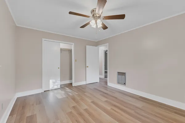 an empty room with fan and a ceiling fan