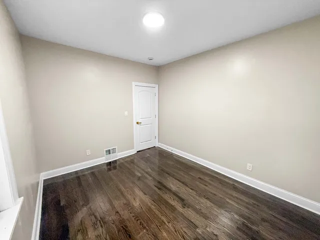 a view of room with wooden floor