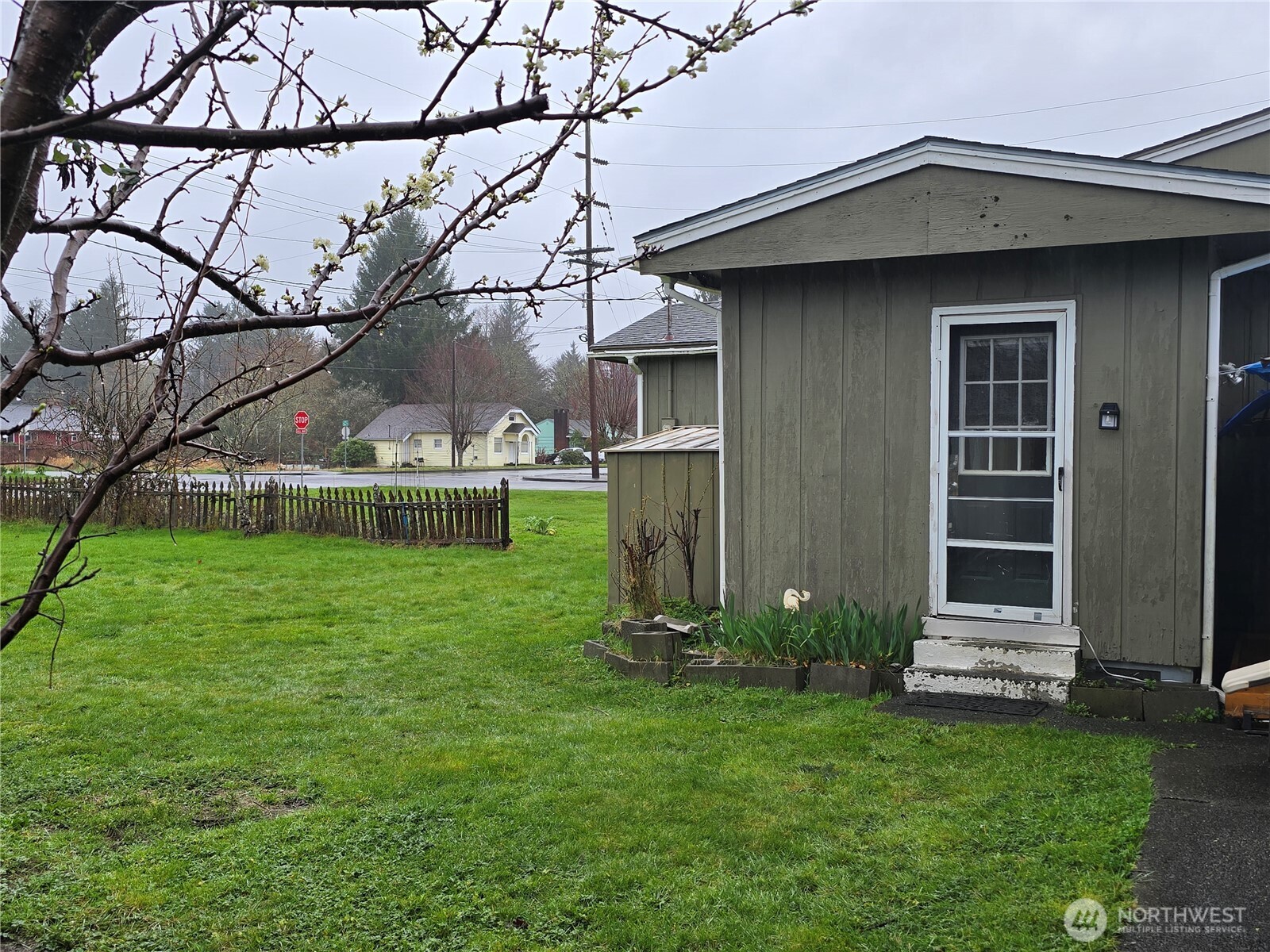 117 J Street Cosmopolis, WA 98537 - Photo 26 of 30 a view of a house with a small yard and wooden fence