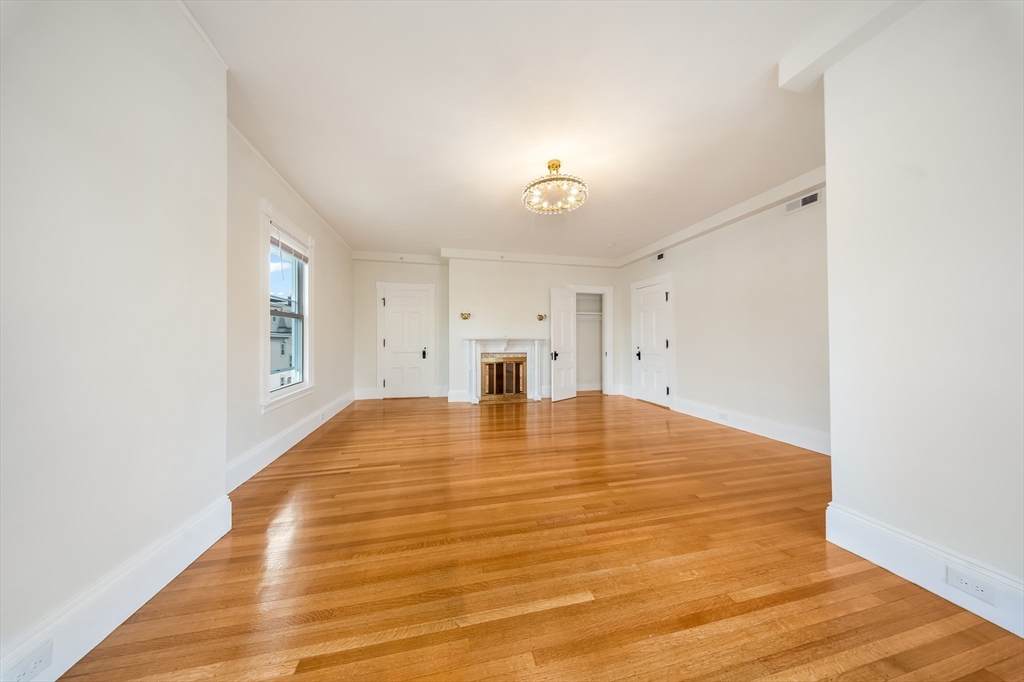180 Jackson Street, Unit B Lawrence, MA 01841 - Photo 3 of 8 a view of empty room with wooden floor