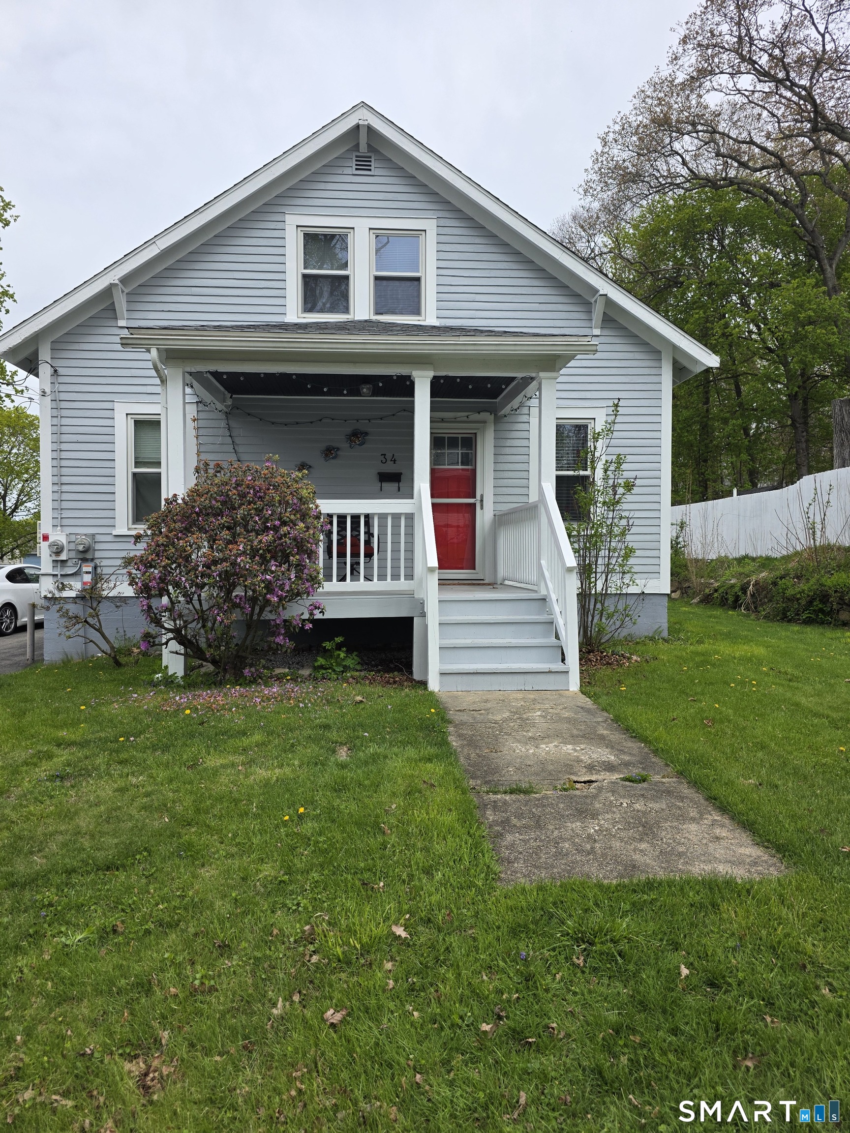 a front view of a house with a yard and fence