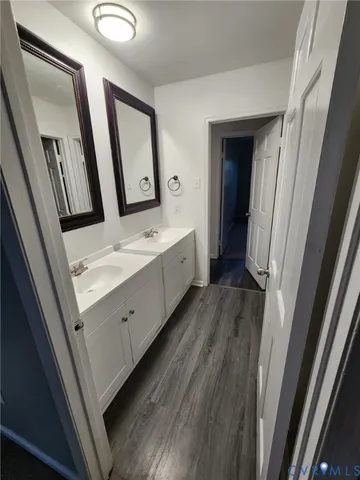 a bathroom with a double vanity sink and mirror