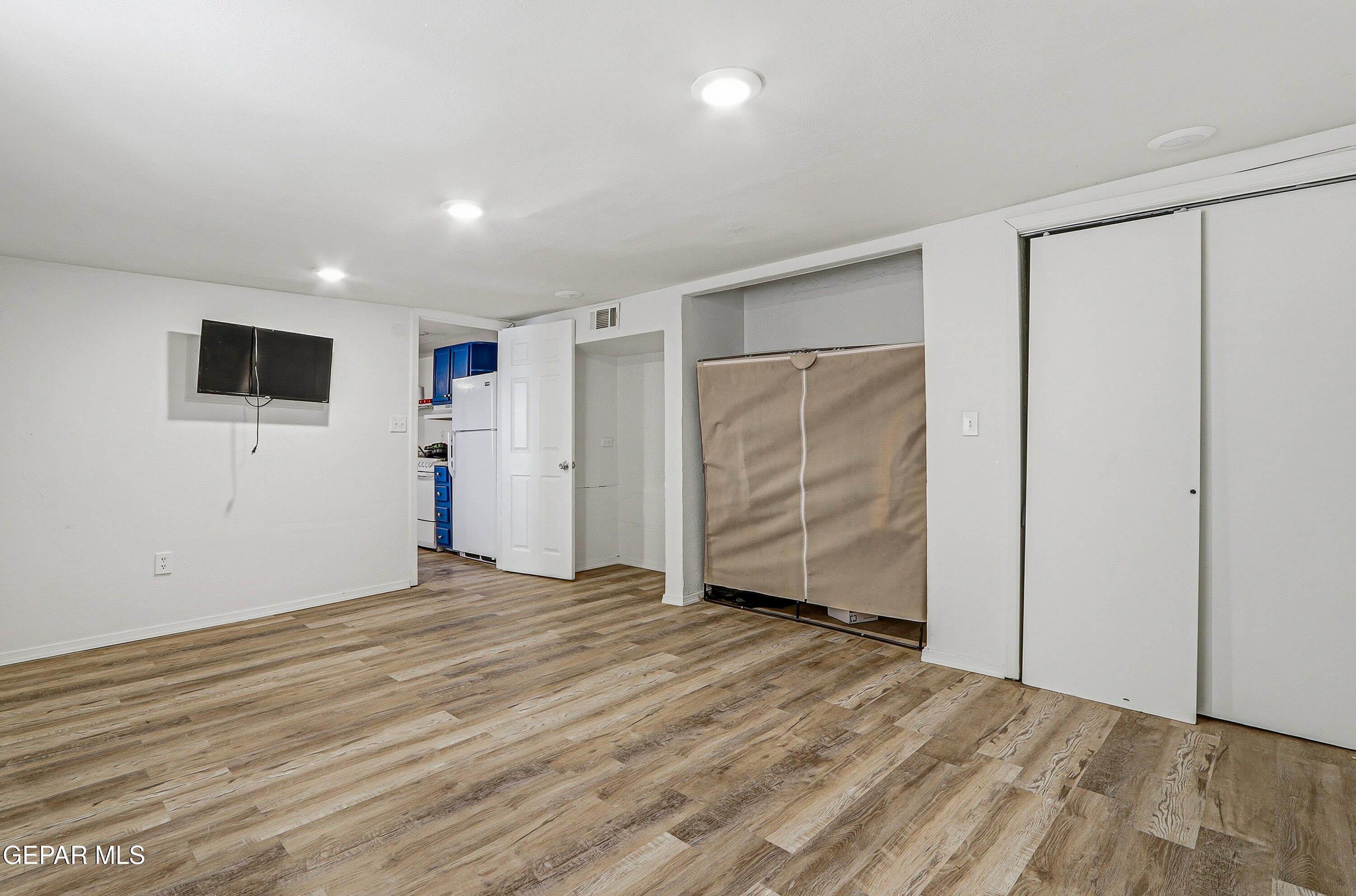 11548 Jenny Road Socorro, TX 79927 - Photo 16 of 39 a view of an empty room with wooden floor and closet area