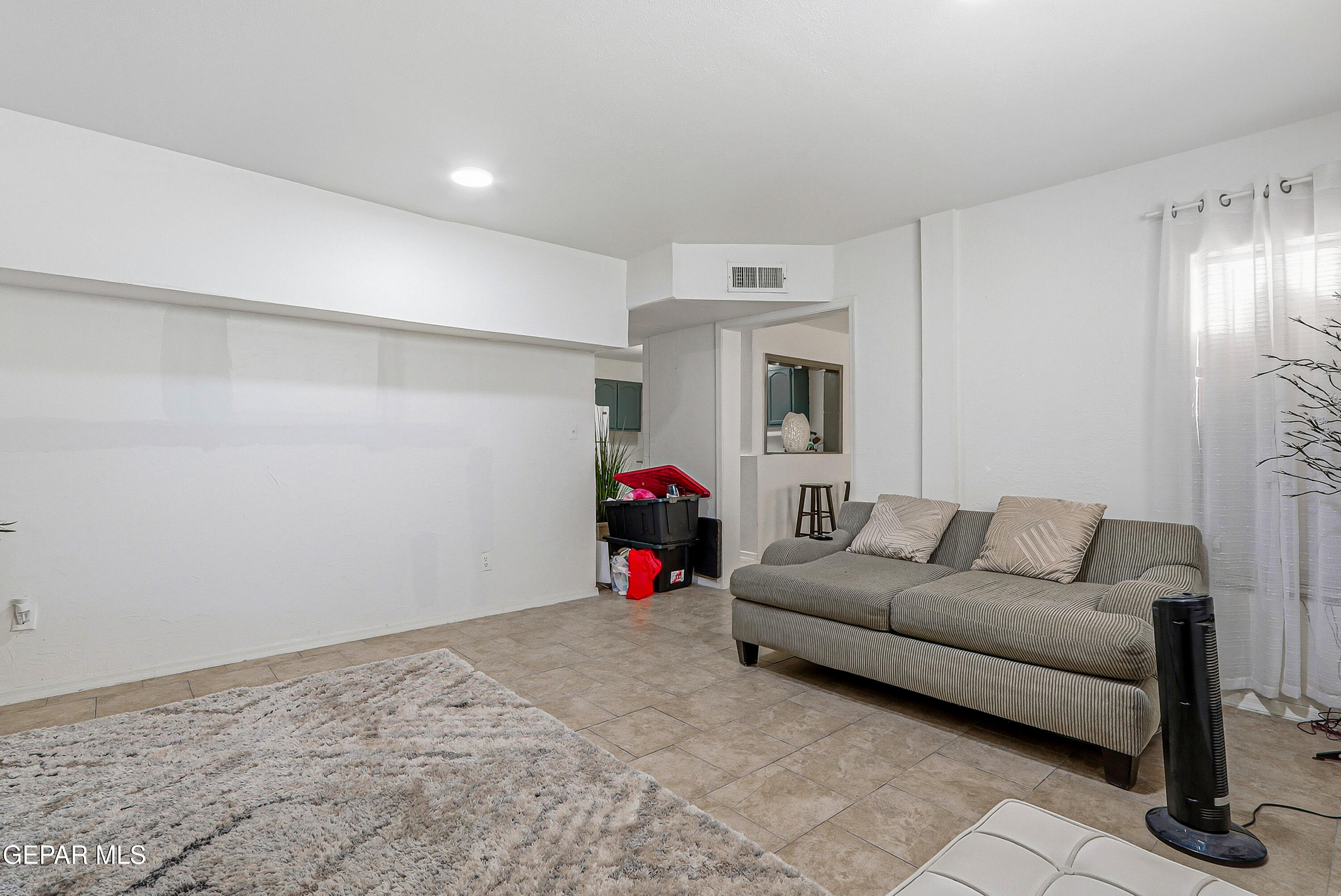 11548 Jenny Road Socorro, TX 79927 - Photo 22 of 39 a living room with furniture and a fireplace