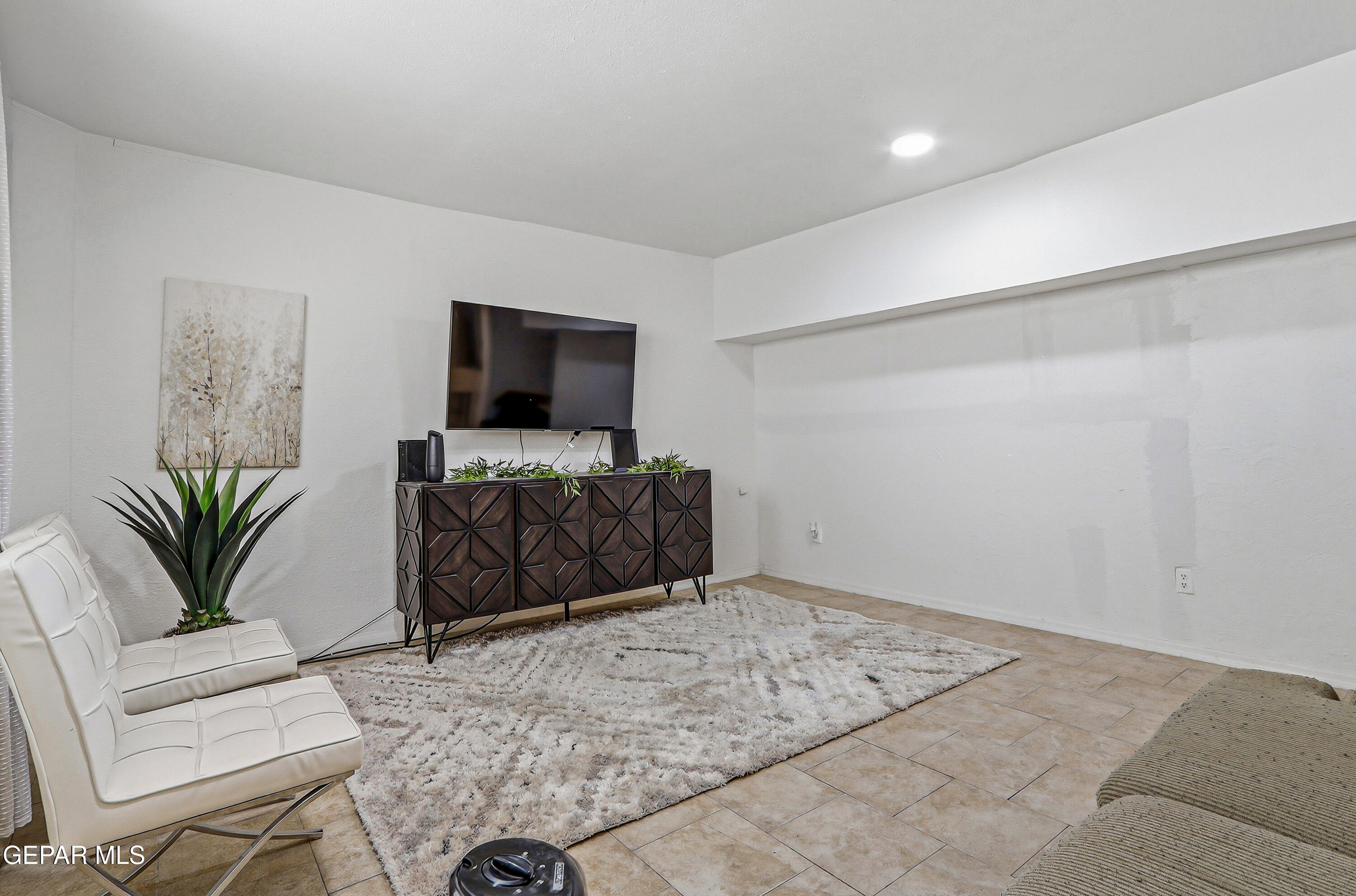 11548 Jenny Road Socorro, TX 79927 - Photo 23 of 39 a living room with furniture and a flat screen tv