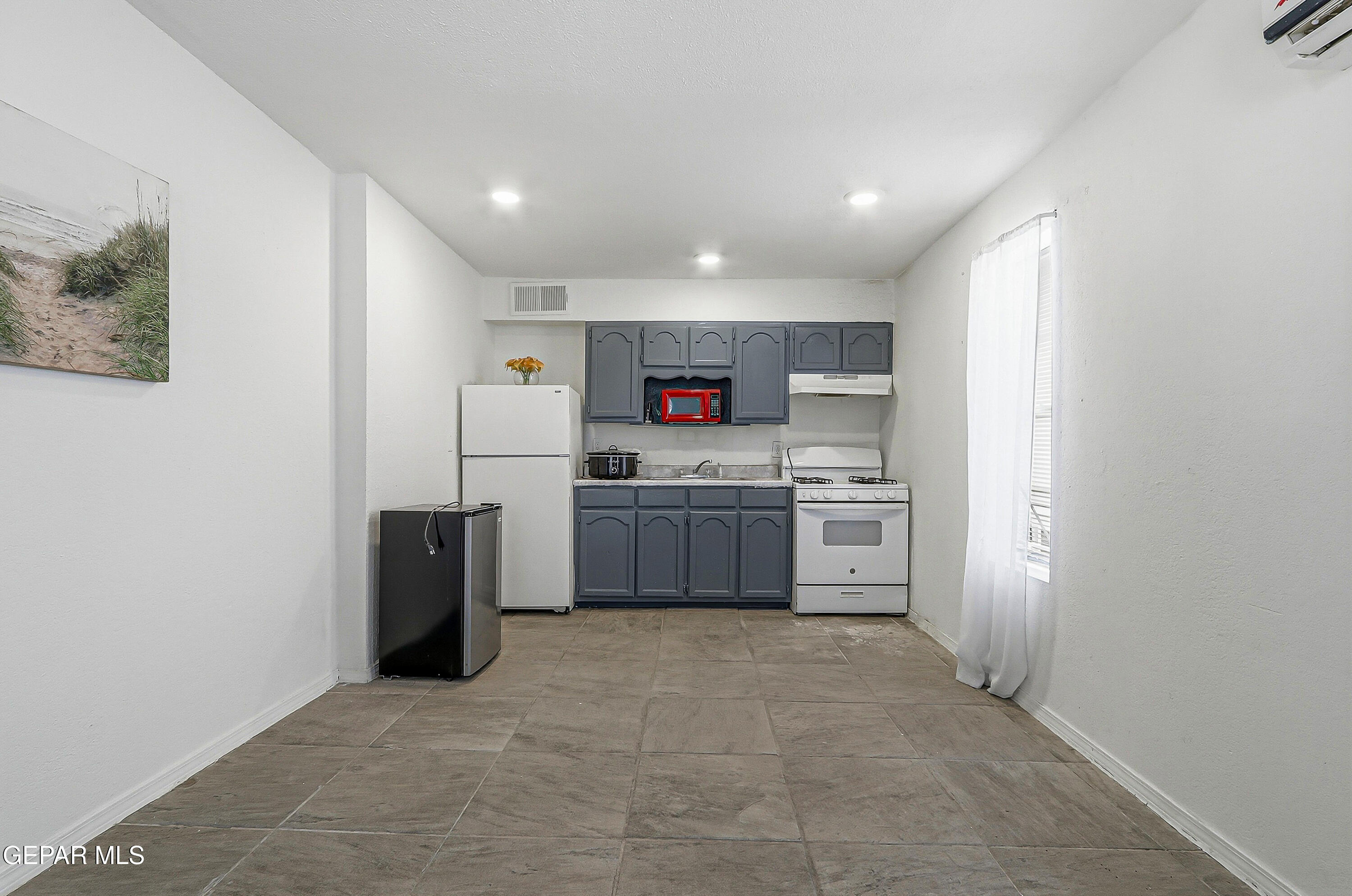 11548 Jenny Road Socorro, TX 79927 - Photo 5 of 39 a kitchen with white cabinets and white appliances