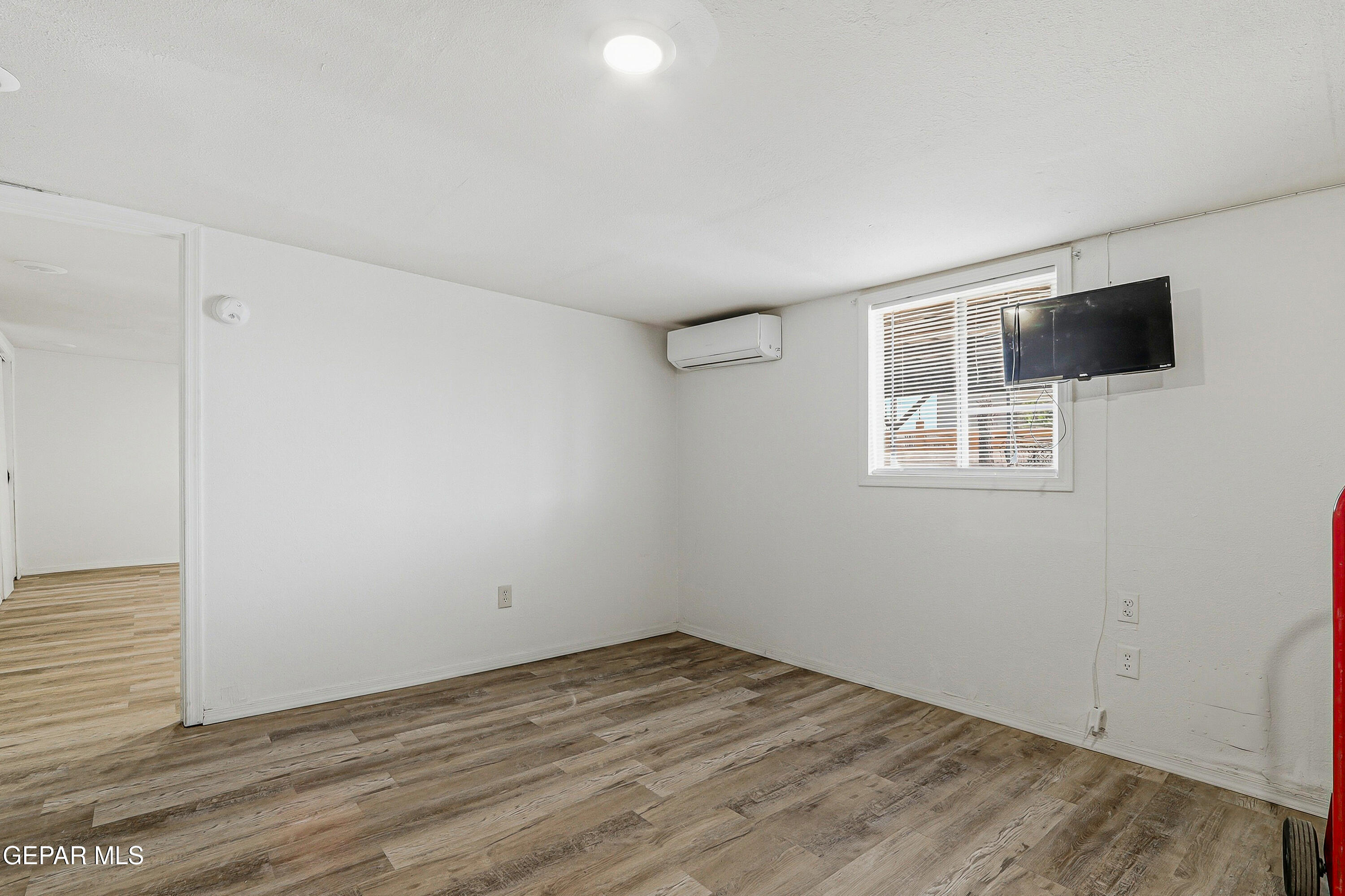 11548 Jenny Road Socorro, TX 79927 - Photo 10 of 39 a view of empty room with wooden floor and windows