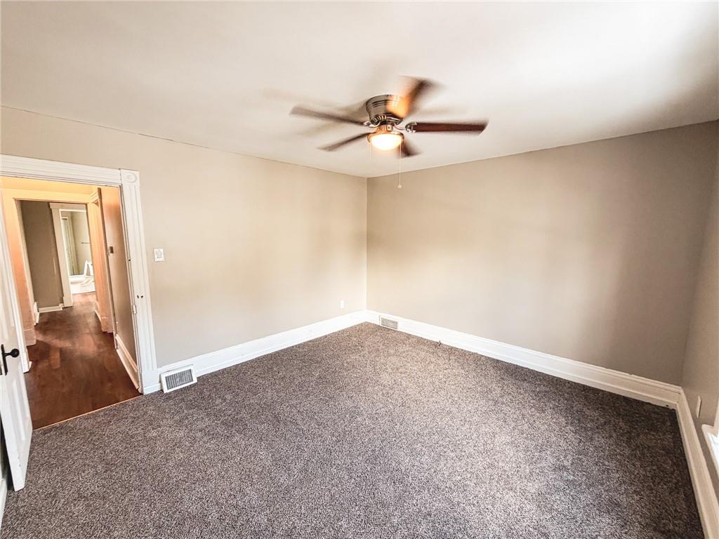 330 12th Avenue, Unit 2 New Brighton, PA 15066 - Photo 16 of 17 an empty room with a ceiling fan and carpet