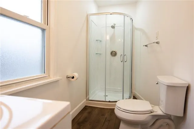 a bathroom with a toilet and a shower