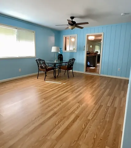 a view of a livingroom with furniture and a window