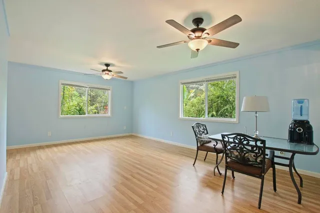 a view of a dining room with furniture a rug and wooden floor