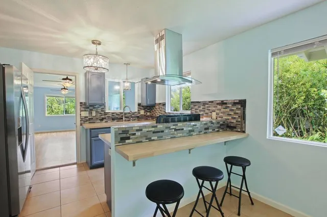 a kitchen with stainless steel appliances granite countertop a stove a refrigerator and a counter space