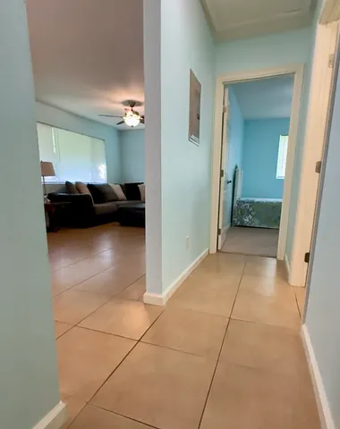 a view of a bedroom with a furniture and a ceiling fan