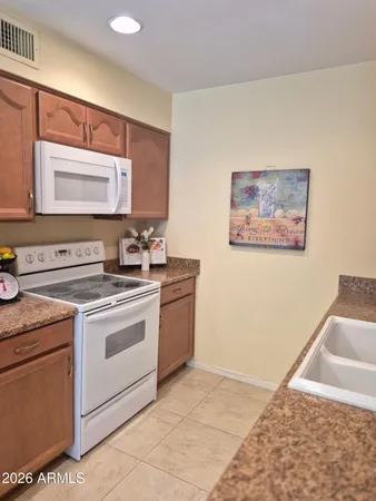 a bathroom with a refrigerator and mirror
