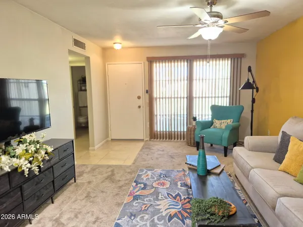 a living room with furniture and a potted plant