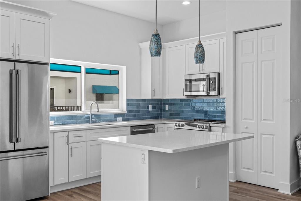 15405 Gulf Boulevard, Unit B2 Madeira Beach, FL 33708 - Photo 13 of 49 a kitchen with stainless steel appliances a sink and a refrigerator