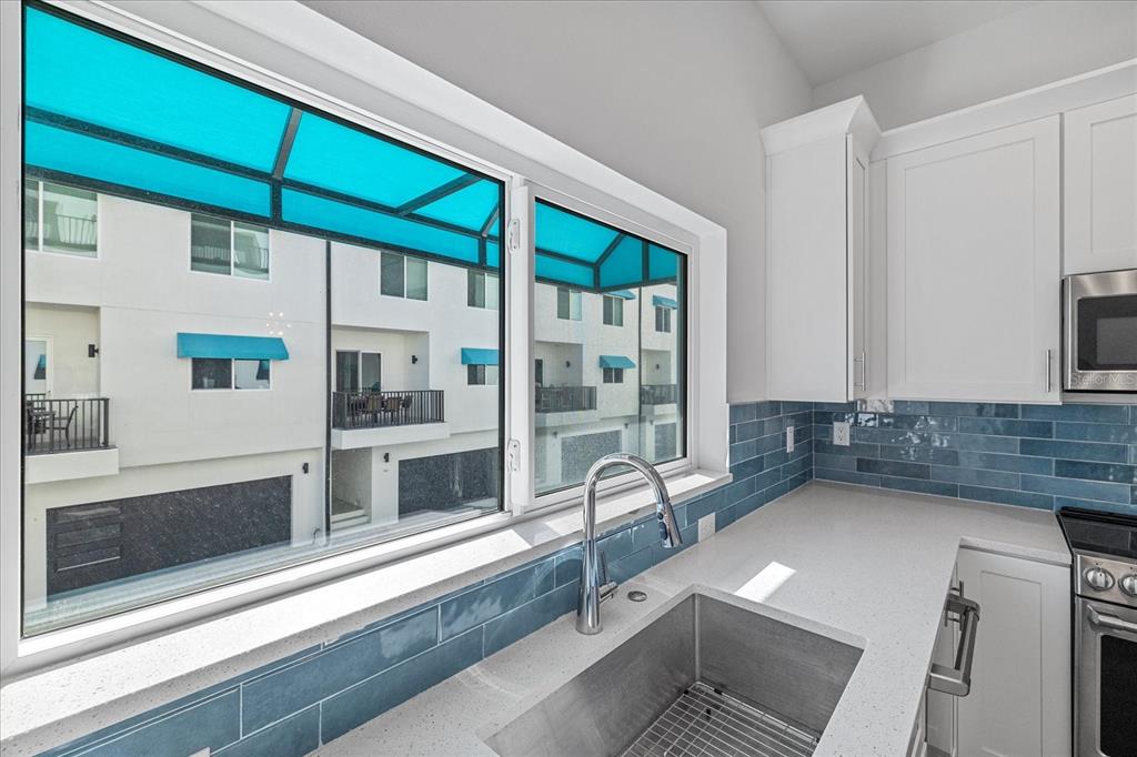 15405 Gulf Boulevard, Unit B2 Madeira Beach, FL 33708 - Photo 16 of 49 a kitchen with stainless steel appliances a sink and a stove