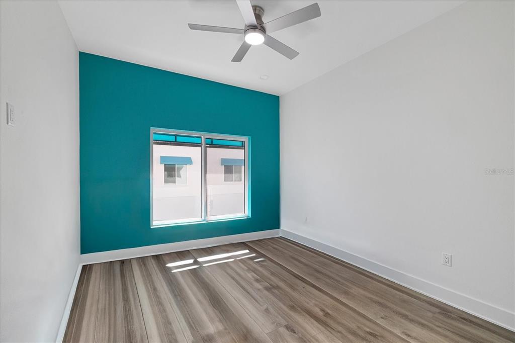 15405 Gulf Boulevard, Unit B2 Madeira Beach, FL 33708 - Photo 23 of 49 an empty room with wooden floor cabinet and windows