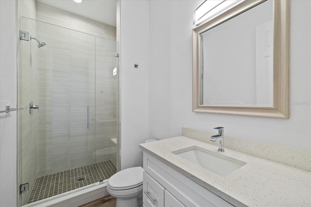 15405 Gulf Boulevard, Unit B2 Madeira Beach, FL 33708 - Photo 26 of 49 a bathroom with a sink toilet vanity and shower