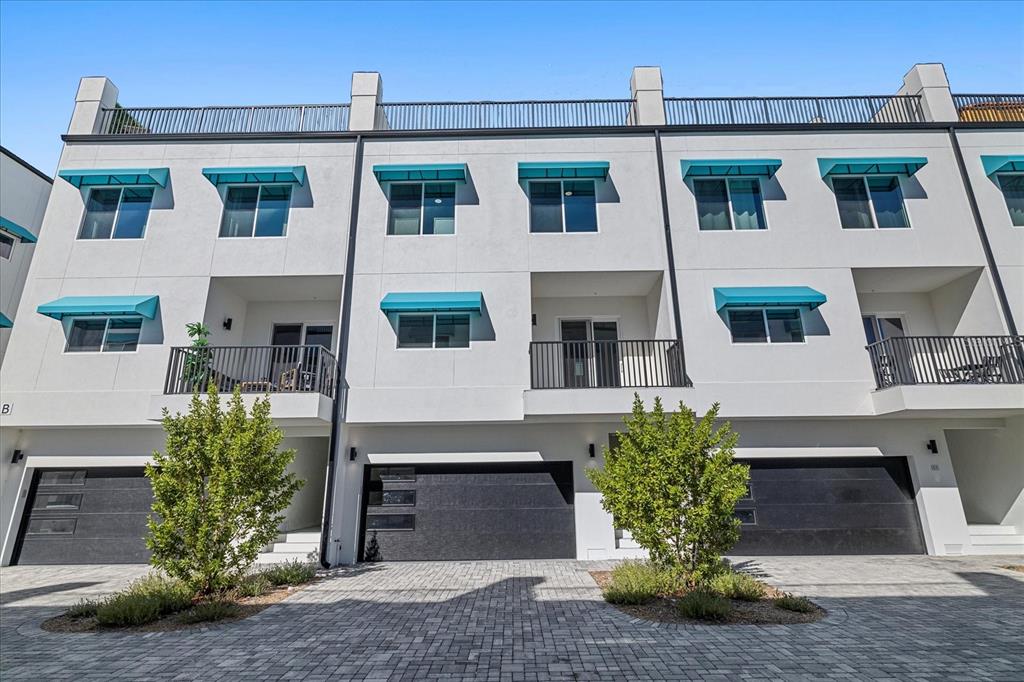 15405 Gulf Boulevard, Unit B2 Madeira Beach, FL 33708 - Photo 3 of 49 a front view of a house with garden