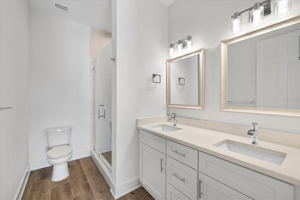 15405 Gulf Boulevard, Unit B2 Madeira Beach, FL 33708 - Photo 34 of 49 a bathroom with a toilet sink and mirror