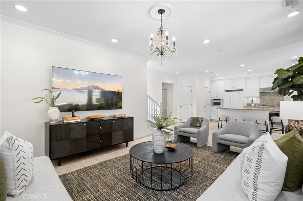 61 Lupari Irvine, CA 92618 - Photo 17 of 65 a living room with furniture kitchen view and a chandelier