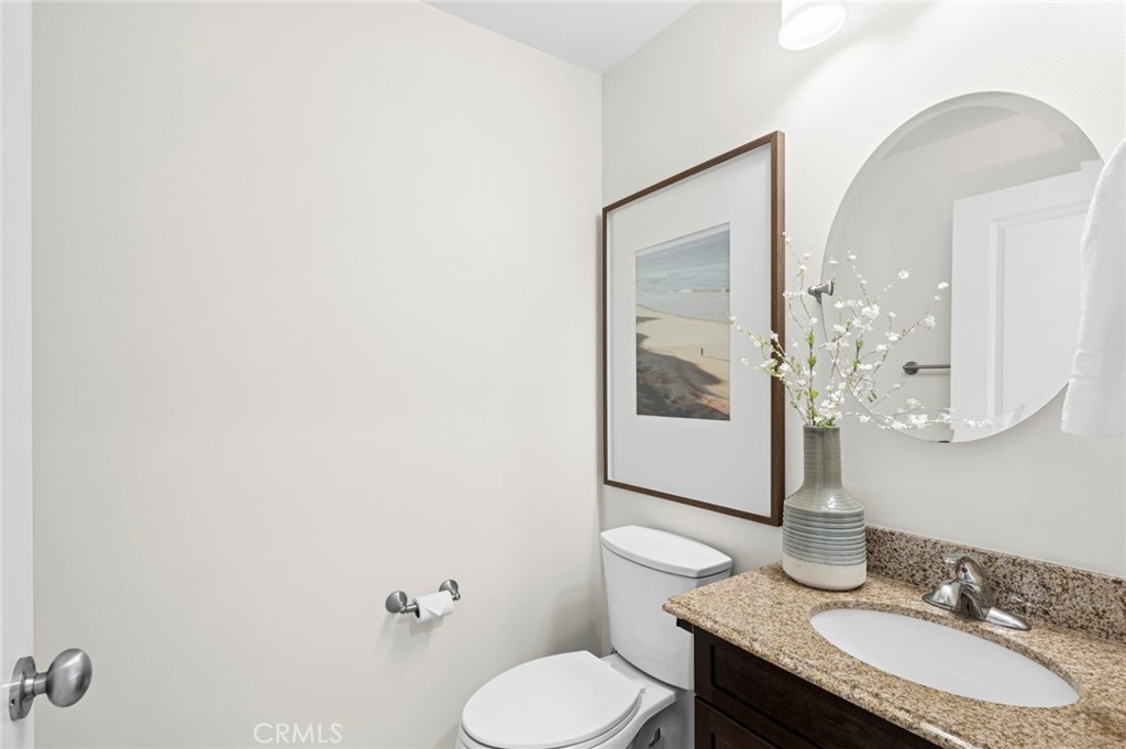61 Lupari Irvine, CA 92618 - Photo 18 of 65 a bathroom with a granite countertop toilet sink and mirror