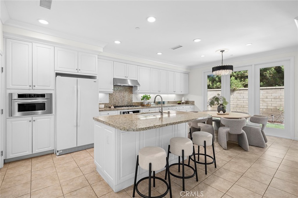 61 Lupari Irvine, CA 92618 - Photo 3 of 65 a kitchen with white cabinets and stainless steel appliances