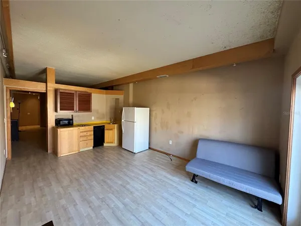 a view of kitchen with furniture and wooden floor