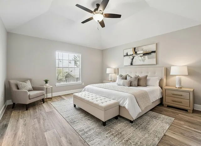 a spacious bedroom with a bed and a couch