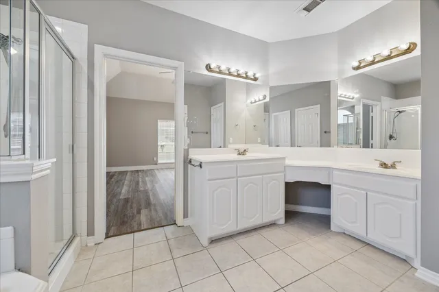 a bathroom with a sink vanity and a mirror