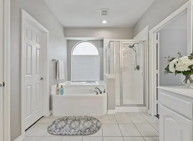 a bathroom with a bathtub and a shower