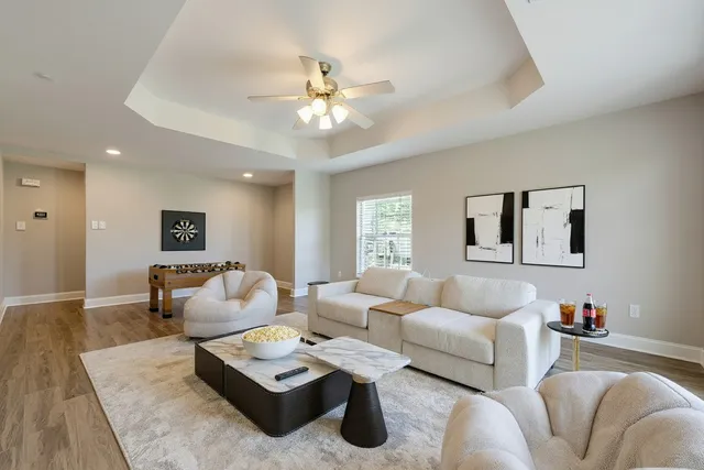 a living room with furniture and a wooden floor