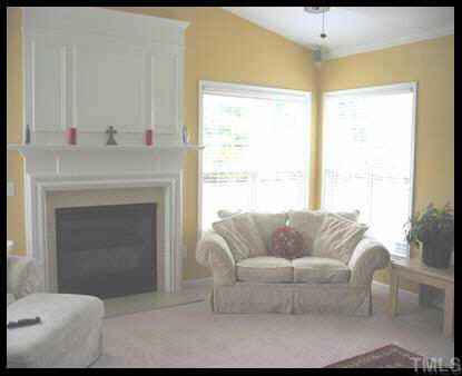 7616 Silver View Lane Raleigh, NC 27613 - Photo 2 of 10 a living room with furniture and a fireplace