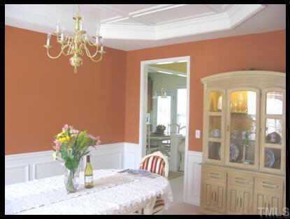 7616 Silver View Lane Raleigh, NC 27613 - Photo 3 of 10 a view of a dining room with furniture a chandelier and a large mirror