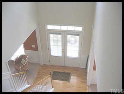 7616 Silver View Lane Raleigh, NC 27613 - Photo 8 of 10 a view of an empty room with wooden floor and a window