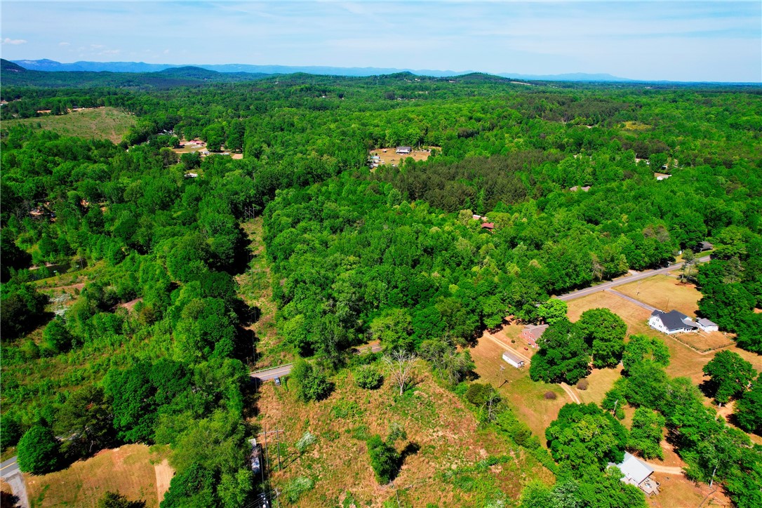903 Cedar Rock Church Road Easley, SC 29640 - Photo 2 of 8 An aerial perspective reveals the expansive, verdant landscape with rolling hills and distant mountains.