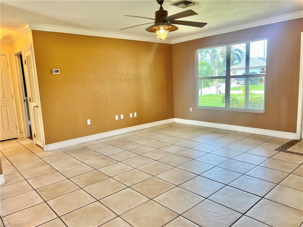 18581 Tampa Road Fort Myers, FL 33967 - Photo 10 of 25 Spare room featuring light tile patterned floors, ceiling fan, and ornamental molding